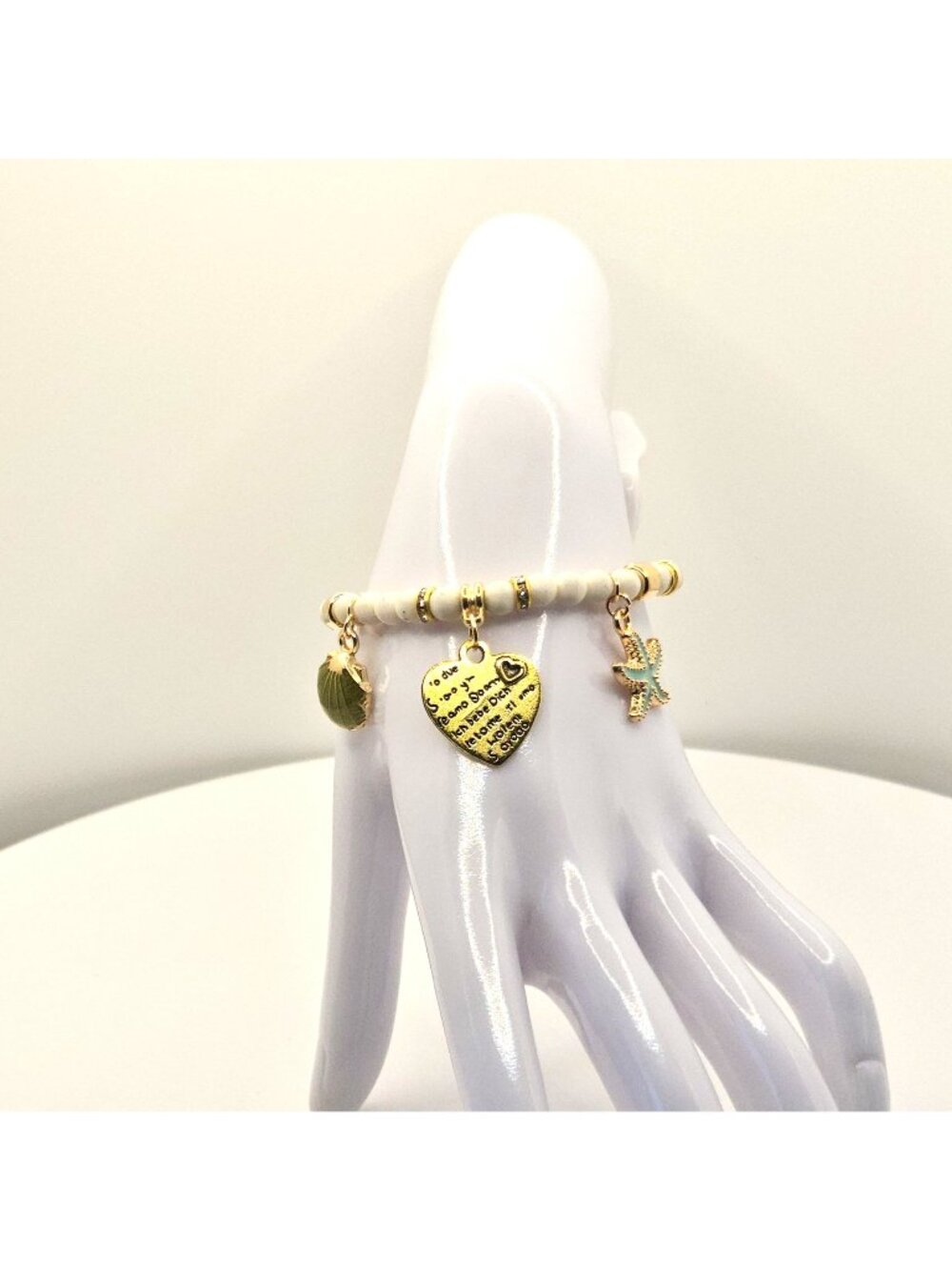 Gold And White Beaded Charm Bracelet With Heart Shell And Starfish Accents Stret